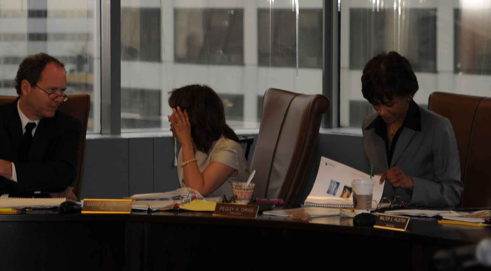 Above, CTPF attorney Joseph Burns in discussion with Teacher Trustee Maria Rodriguez, who works as a Field Rep for the Chicago Teachers Union. To the left of Rodriguez is Peggy Davis, the second Trustee who represents the Chicago Board of Education. During the meeting, Rodriguez repeatedly covered her face when Substance was photographing the meeting. Substance photo by George N. Schmidt.
