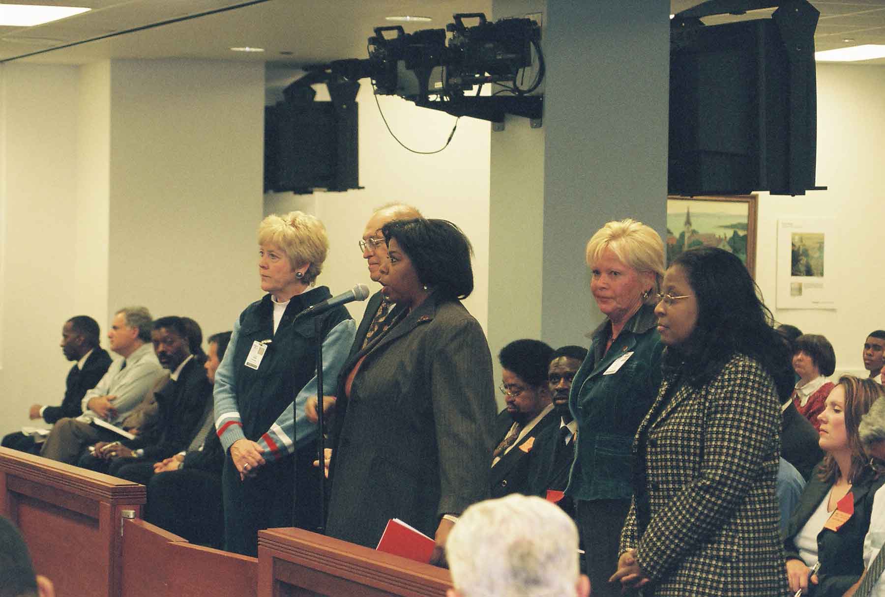 When Chicago Teachers Union President Marilyn Stewart appeared before the Chicago Board of Education at its January 10, 2006 meeting (above) the union’s members did not know that increased pay and benefits for her top staff were slowly bankrupting the 31,000-member union. Surrounding Marilyn above are (left to right): Coleen Dykas; Peter Ardito; Sandy Schultz; and Traci Cobb Evans. By the time this photograph was taken, coordinators such as those above were being paid for a ‘53-week year’ and had unprecedented fringe benefits. Two years later, many of the deals are still secret. Substance photo by George N. Schmidt. 