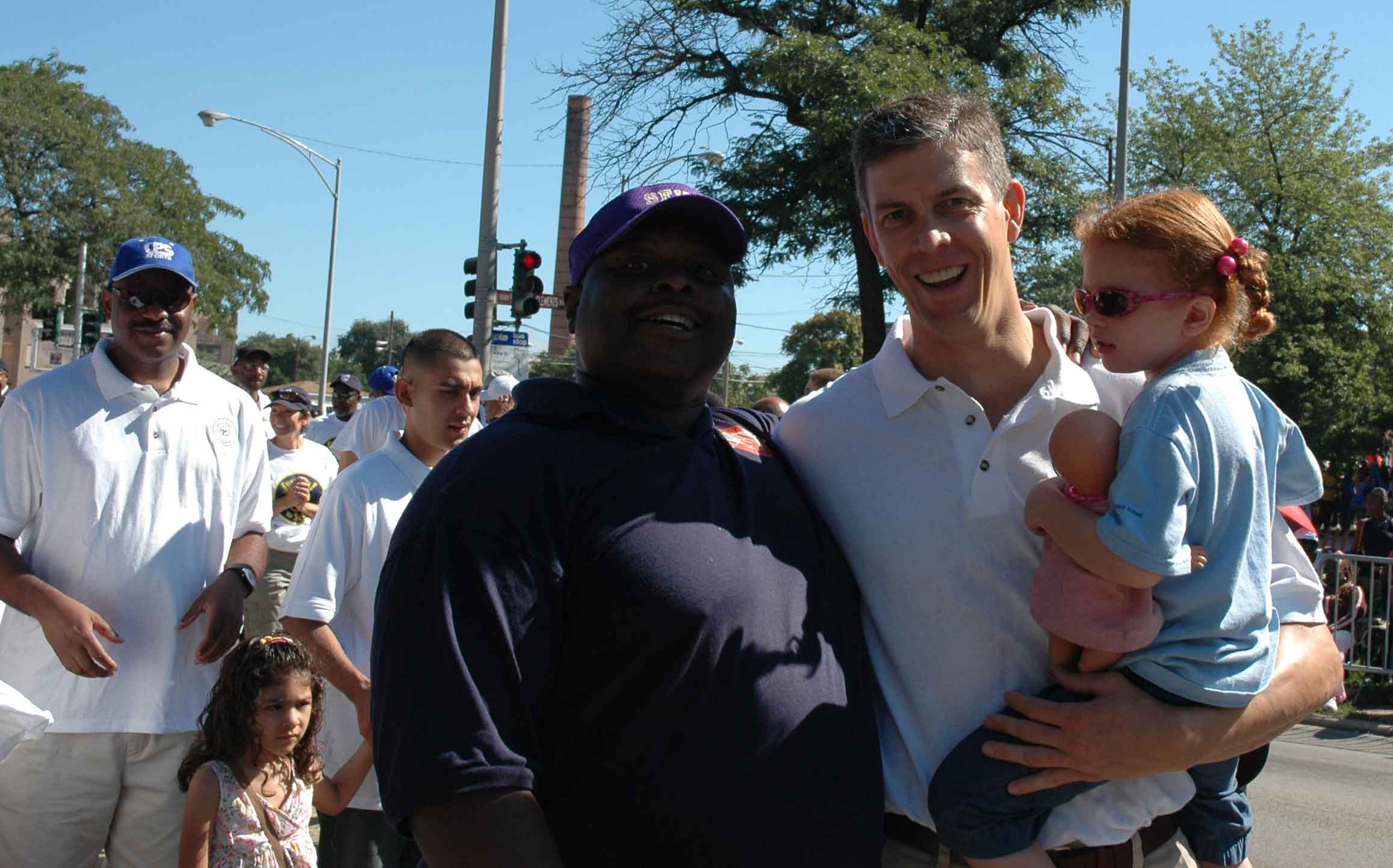Former Chicago Schools Chief Executive Officer Arne Duncan (above right, at Chicago's Bud Billiken Day Parade on August 12, 2006) has now established the Chicago Plan to fire teachers from inner city schools as a national program thanks to President Barack Obama. Substance photo by George N. Schmidt.