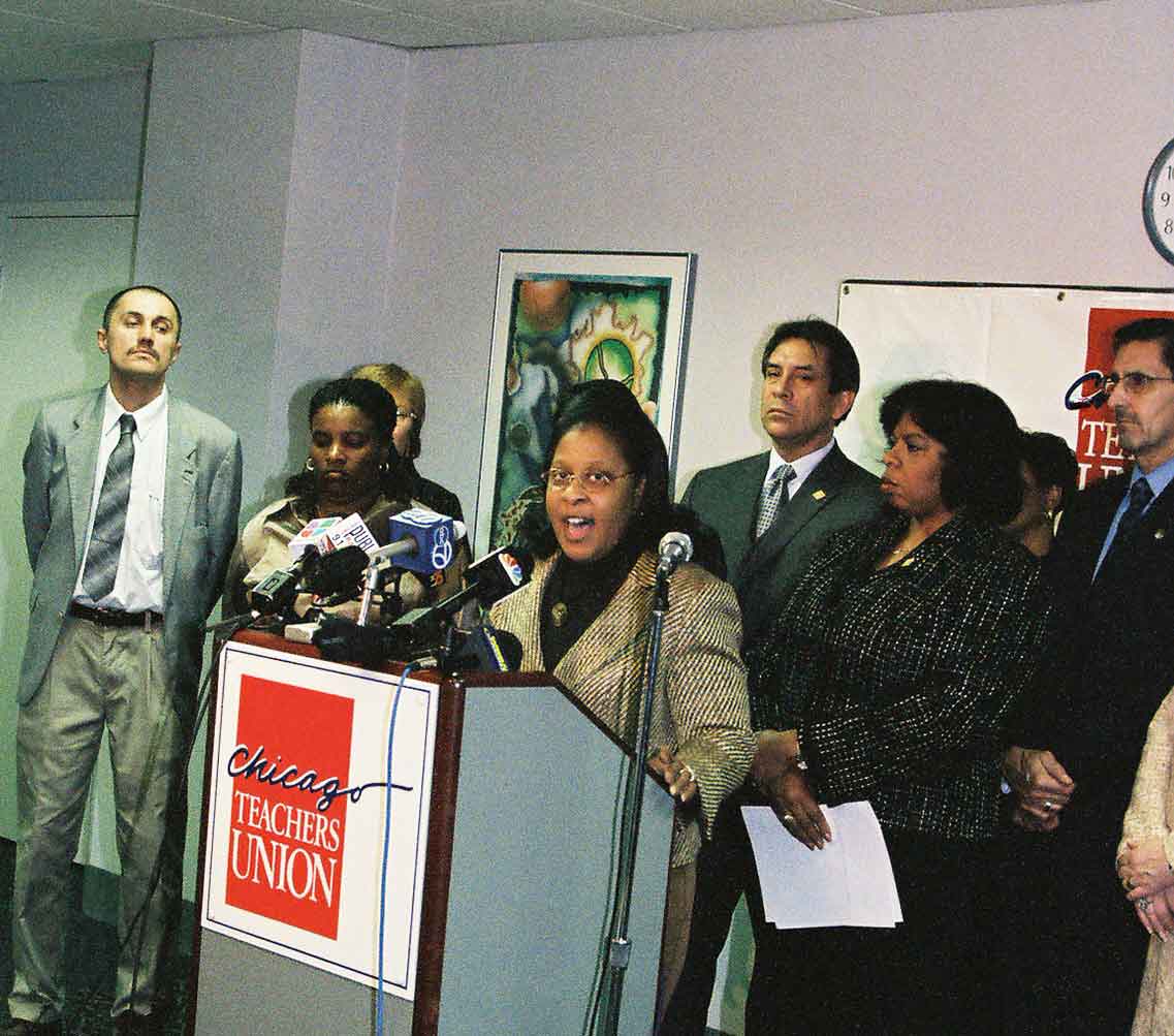 Hyde Park High School delegate John Kugler (far left above) looks on as Chicago Teachers Union officers discuss the increase in violence at Wells and Hyde Park high schools following the September 2004 decision of the Chicago Board of Education to privatize Austin High School on the West Side and Calumet High School on the South Side. Beginning in September 2004, 9th grade students from both schools who would have attended Austin and Calumet were forced to find other schools, often increasing gang violence at the receiving schools. At the March 2005 press conference above, students from Wells and Hyde Park described the increased gang violence that resulted from the significant influx of new students. At the microphone (above) was Traci Cobb-Evans, who was hired by CTU President Marilyn Stewart to be the union's $100,000 per year Legislative Coordinator despite the fact that Cobb-Evans had crossed the picket lines (scabbed) during the 1987 strike. Kugler first reported the confirmation of that story in the March 2008 Substance, three years after the above photo was taken. Substance photo by George N. Schmidt. 