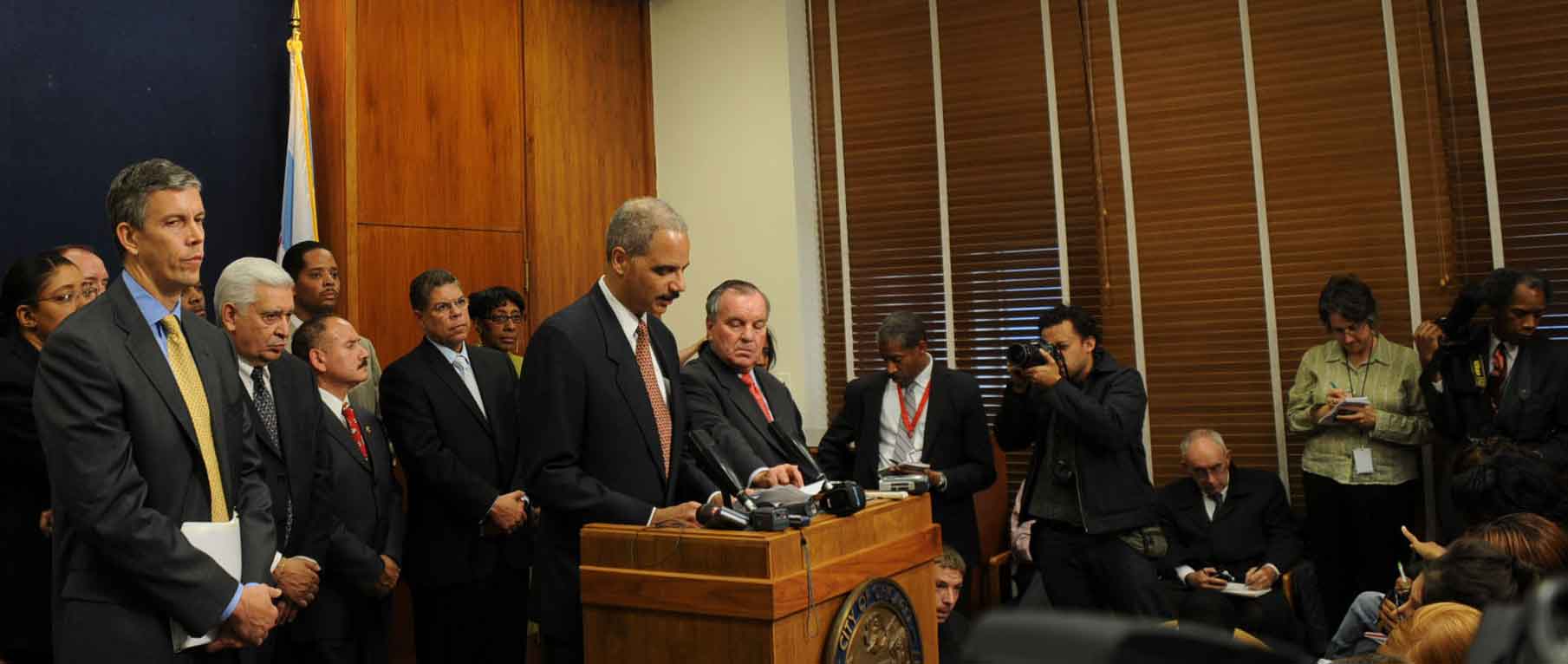 U.S. Attorney General Eric Holder (above, at podium) spoke carefully regarding the brutal murder of Fenger High School student Derrion Albert and 'youth violence' in general during the heavily attended press conference at Chicago's City Hall on October 7, 2009. Holder was one of three individuals who spoke and answered questions from the nearly 100 reporters and camera crews from around the world that jammed into the stuffy room for the media event. The other two were U.S. Secretary of Education Arne Duncan (second from left, above) and Chicago Mayor Richard M. Daley (to the right of Holder, above). Substance photo by George N. Schmidt.