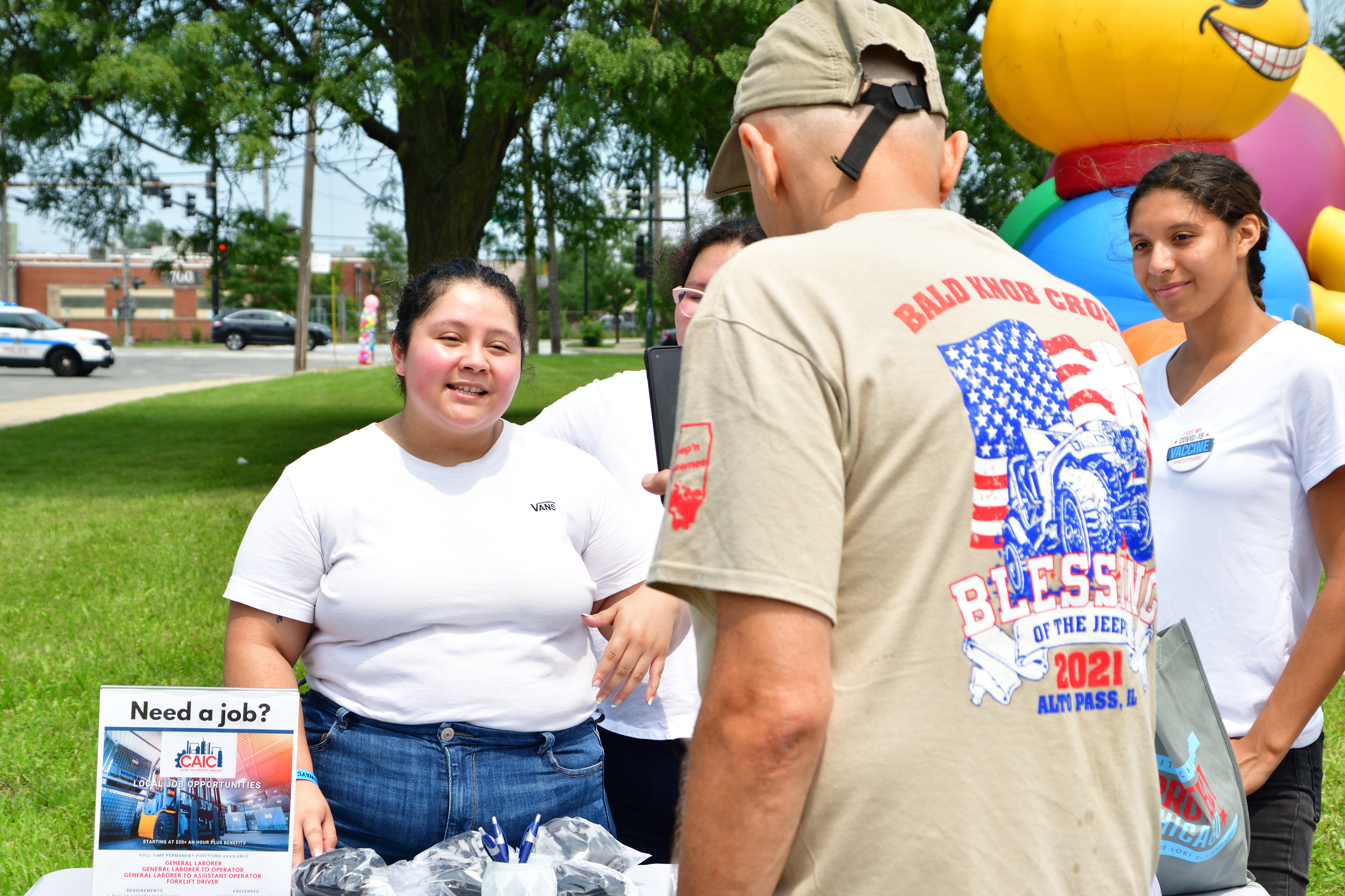 Dr. John Kugler talking to Calumet Area Industrial Commission Representative, Community Festival 2021, 5th District Chicago Police Headquarters, July 17, 2021 (pic by Emi Yamamoto)