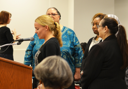 Accompanied by Chicago Teachers Union President Karen Lewis (half obscured behind the speaker) and CTU Quest Center and NBCT coordinator Lynn Cherkasky-Davis (above right),one of the more than 100 new NBCT teachers told the the Chicago Board of Education about her work and the program. After praising the program, the Board then went into its meeting, where teachers were again disregarded and major Power Point presentations on educational issues were delivered by highly paid CPS executives who had never taught in Chicago schools and whose main qualifications for their current administrative offices are the fact that they hold MBA degrees and are willing to deliver carefully scripted Power Point presentations in support of usually destructive corporate school reform programs. Substance photo by George N. Schmidt. 