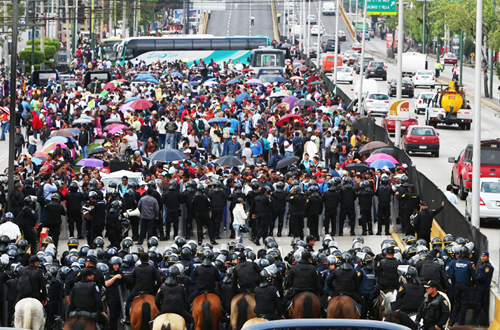 Like his counterpart to the north, the President of Mexico knows that the real threat to his nation is not greedy CEOs, corrupt corporations, or drug gangs -- so he sends his army and police, including mounted cops on horses, to attack protesting teachers. Photo by Al Jazeera.