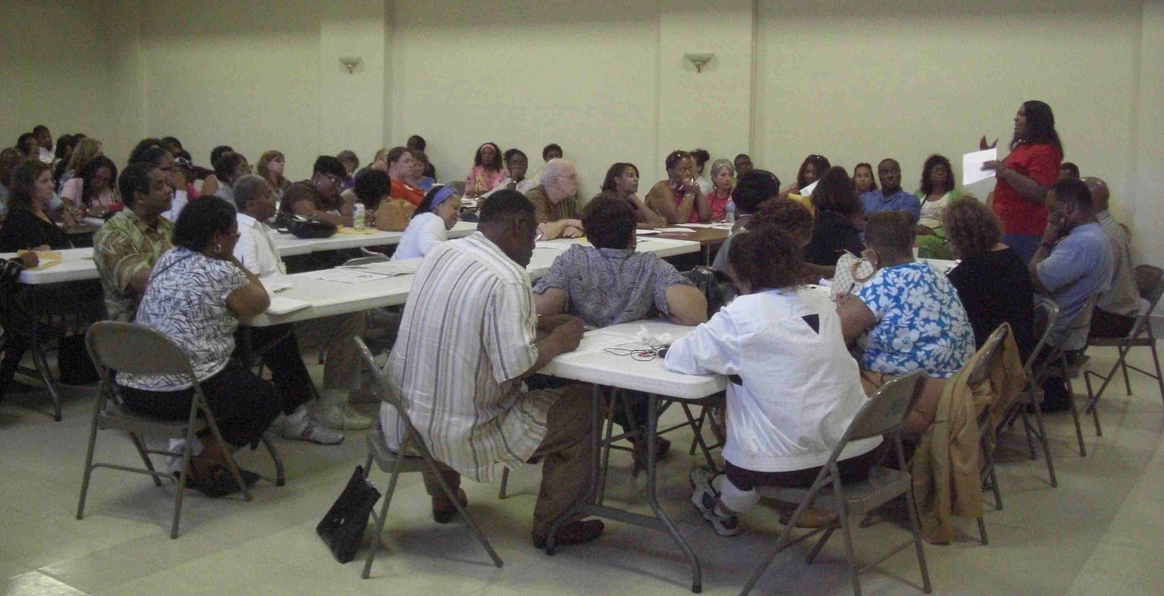 More than 100 teachers, most of them to be terminated on July 1 on orders of Chicago Public Schools Chief Executive Officer Ron Huberman, were at the June 29 meeting at Operation PUSH on Chicago's South Side. Above, Rosita Chatunda (right side, back) speaks to the group about how grievances and possible litigation could be organized. Substance photo by John Kugler.