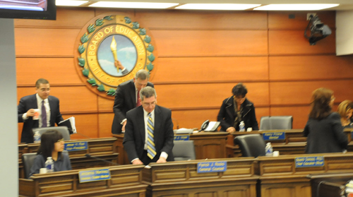 DECEMBER 14, 2011. Above, the members of the Chicago Board of Education and executives pack their papers for what many are now calling 