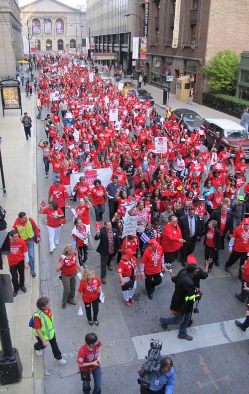 May 23, 2012, 44 years after the first strike by Chicago teachers, on Adams St. in Chicago Illinois, Chicago Teachers Union President Karen Lewis led a march of 10,000 people, most of them CTU members, through Chicago's Loop following rallies at the Auditorium Theatre and in Grant Park against the policies of the Chicago Board of Education. Lewis can be seen in the above photograph with the Rev. Jesse Jackson Jr., American Federation of Teachers (AFT) President Randi Wingarten. and Illinois Federation of Teachers (IFT) President Dan Montgomery leading the march, which stretched for more than five blocks as it worked its way from Michigan Ave. to its end point on LaSalle St. Substance photo by Sharon Schmidt.