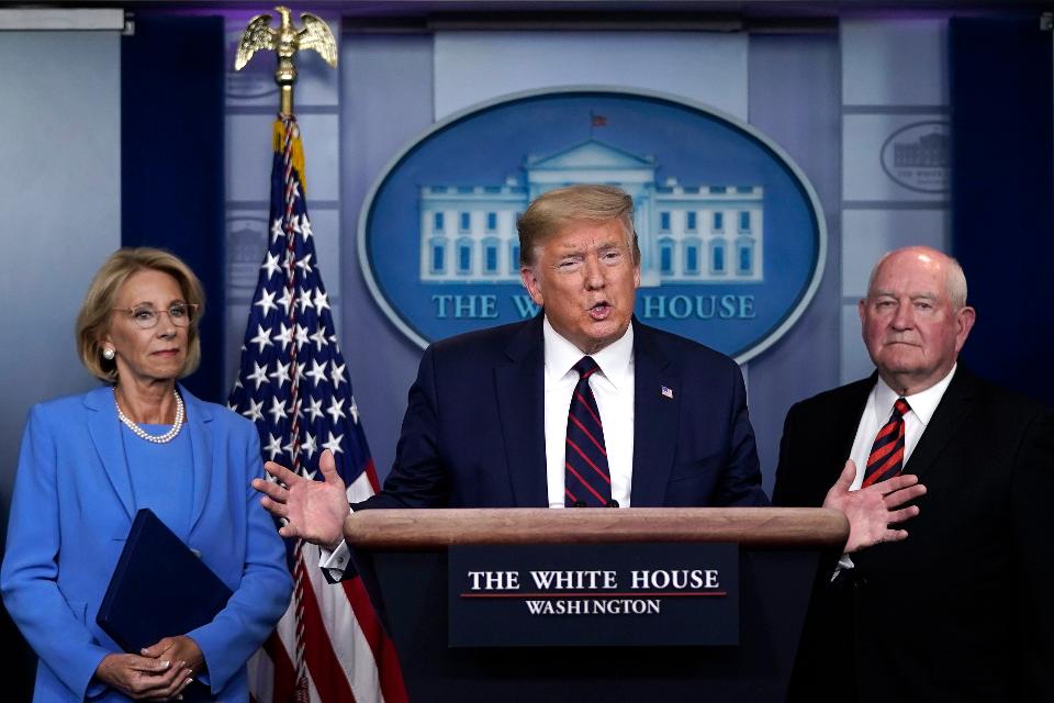 WASHINGTON, DC - MARCH 27: U.S. President Donald Trump sas Secretary of Education Betsy DeVos and Secretary of Agriculture Sonny Perdue look on during a briefing on the coronavirus pandemic in the press briefing room of the White House on March 27, 2020 in Washington, DC. President Trump signed the H.R. 748, the CARES Act on Friday afternoon. Earlier in the day, the U.S. House of Representatives approved the $2 trillion stimulus bill that lawmakers hope will battle the economic effects of the COVID-19 pandemic. (Photo by Drew Angerer/Getty Images) GETTY IMAGES