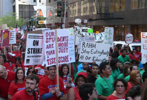 Depending upon whose counting you believe, between 10,000 and 50,000 teachers and their families and supporters filled Chicago's Loop for the rally and march on the first day of the Chicago Teachers Strike of 2012. The rallies during the strike (and before it, as far back as May 23 following the CTU rally at the Auditorium Theatre) were the largest union protests sustained over more than a week in the history of Chicago. Above, some of the marchers who filled Clark St. from City Hall to the Federal Reserves Bank on the afternoon of September 20, 2012. Substance photo by Kati Gilson.