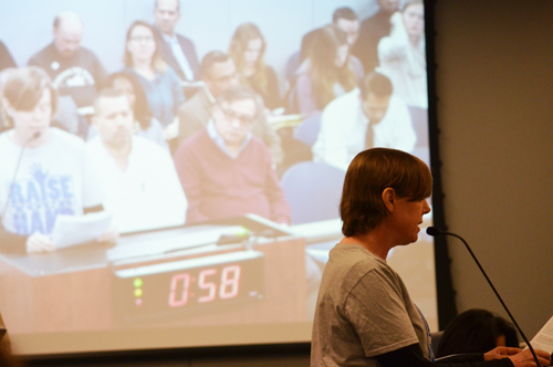 Joy Clendenning, of Raise Your Hand, listed the illegal attacks on Opt Out children, parents and teachers. The Board members basically ignored the protest. Substance photo by George N. Schmidt.