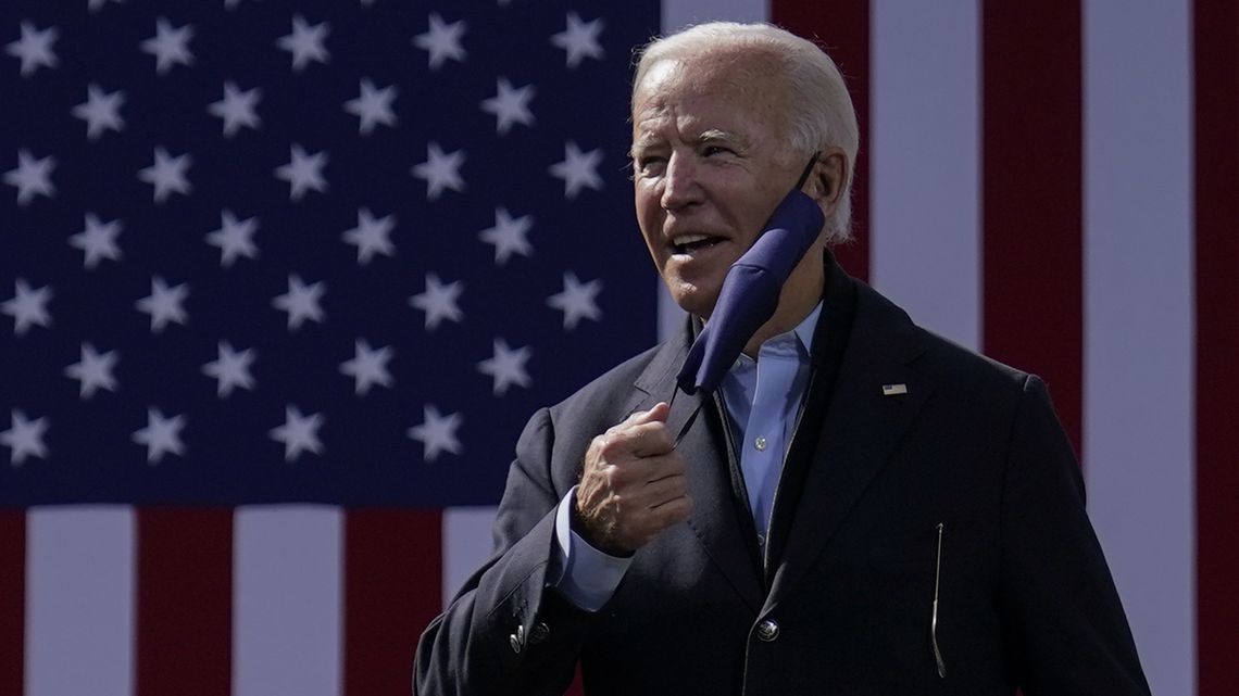 Democratic presidential candidate Joe Biden removes his facemark as he arrives to speak during a campaign event at Riverside High School in Durham, N.C., Sunday, Oct. 18, 2020. (AP Photo/Carolyn Kaster) [ CAROLYN KASTER | AP ]