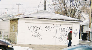 After school activities at Gage Park High School were cancelled for several days in March 2007 because of gang problems in the surrounding community. Above, a garage across the street from the school proclaims the Maniac Latin Disciples (MLDs). The MLDs are part of the “Folks” street gang alliance in Chicago and suburbs, represented by the six-pointed star. Part of the problem at Gage Park is that on of the most important gang border in the community (separating “People” from “Folks” is two blocks north of the school. Once spring arrives, gang fights between the Latin Kings (north of 55th St.) and various branches of the Disciples become more and more common. (Substance photo by George N. Schmidt). 