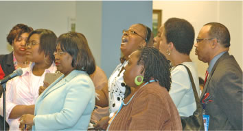 Lawrence Elementary problem leads to confrontation, later arrest. As security approaches (far right in photo above), Charlene Moore (head raised), one of a dozen parents from Lawrence Elementary School (9928 S. Crandon) challenges the characterization by Board of Education executive Jacqueline Anderson (at microphone) during the Board’s discussion of the situation at Lawrence. Anderson was called on by Board President Rufus Williams and immediately told the Board that the problems at Lawrence resulted from insubordinate behavior by students, parents, teachers, and other staff — who should be following the orders of the school’s new principal. At the time, the Board had forgotten that Ms. Moore had spoken about the security crisis at the school (including a dramatic injury to her son when he attempted to protect a teacher who was being attacked) at the January Board meeting. Although the parents had been at the Board as early as 7:00 a.m. in order to sign up to speak during the 8:00 a.m. to 9:00 a.m. sign up time, when they returned to the school later in the day, Moore was arrested by Chicago Police. According to Moore, the school’s principal claimed that she had put a gun to her head and threatened to kill her earlier in the day in the school’s main office. (Substance photo by George N. Schmidt).