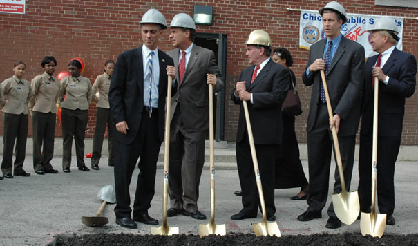 October 15, 2007. Chicago Mayor Richard M. Daley (center, in gold hard hat) joins (left to right) Congressman Rahm Emmanuel, Chicago Alderman Ed Balzer, CEO Arne Duncan, and retired Marine General Michael Mulqueen. Behind Daley (right) on the wall of the former elementary school is the banner of the Chicago Public Schools “Military Area Office” (which CPS claimed does not exist). To the left at ease are 9th grade students from the newly commissioned Marine Military Academy.  At the groundbreaking, Daley and Duncan announced an $8 million expansion of the “Grant Campus” (which now houses the Marine Academy and the Phoenix Military Academy, an Army program). The money for the expansion of the military campus at Adams and Western on Chicago’s West Side comes at a time when Daley and Duncan are telling public schools across Chicago that there is no money for capital improvements in the schools because the State of Illinois has refused to increase Chicago’s percentage of state education funding. Substance photo by George N. Schmidt.