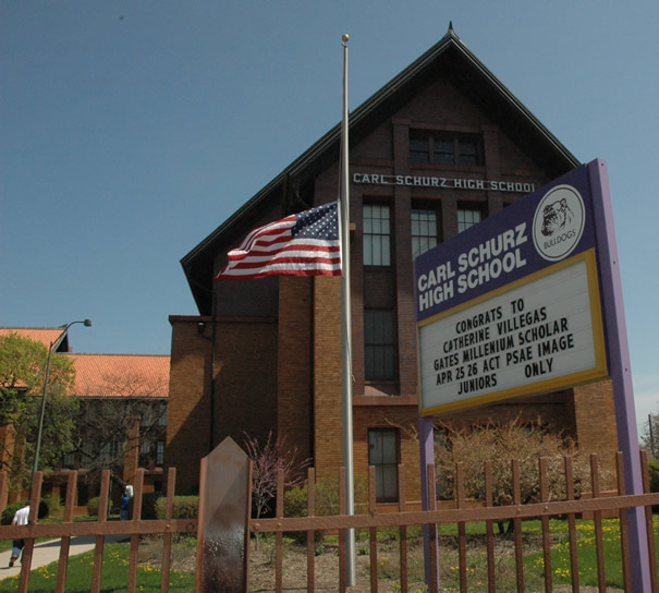 Above: Chicago’s Carl Schurz High School, at 3601 N. Milwaukee Ave., was one of three Chicago general high schools where students walked out of classes during October to protest the scheduling and staffing mess created by the Duncan administration and the implementation of the controversial and expensive IMPACT computer scheduling and record-keeping program. The Schurz walkout, which was the least covered in the media, followed protests at Wells High School (936 N. Ashland) and Julian High School (10330 S. Elizabeth) during which students walked out of their schools. As predicted, the significant cuts (which required reprogramming more than half of the students at least three of the schools) hit almost exclusively at the city’s general high schools. The general high schools, once the center of every community in the city, have been stripped down by the Chicago Board of Education since the beginning of Mayor Richard M. Daley’s rule over CPS in 1995. First Daley ordered the creation of several new “academic magnet” high schools across the city. Then he ordered the creation of charter schools. Both the academic magnet schools and the charter schools carefully select their students, leaving the rest to attend the general high schools. The general high schools are then blamed for test results that can’t possibly be higher given the way the system is organized. Substance Archive photo (April 2007) by George N. Schmidt.