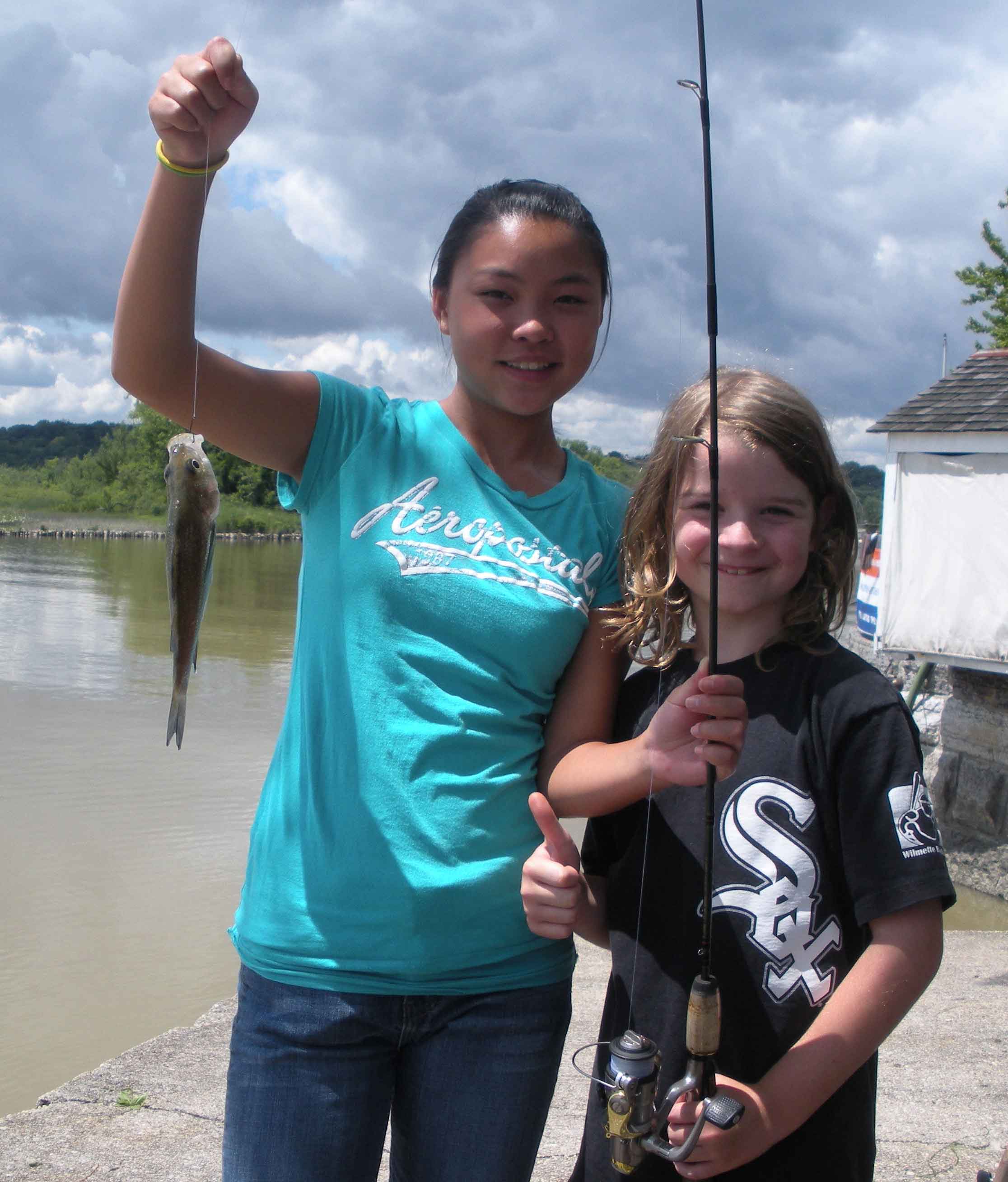 White Sox fan Sam Schmidt (above right) stands as his cousin Jade Forman displays the first fish Sam ever caught on July 10, 2009, at the Hudson River lighthouse in Saugerties, New York. Sam Schmidt, Substance elementary education editor and nature photographer, joined the early boycott of standardized testing in the USA on May 11 and May 12, 2010, by sitting out the tests at his public school in Chicago, while American teachers decide whether to join with their British brothers and sisters in ending the noisome reign of so-called standardized tests in the USA. Substance photo by George N. Schmidt.