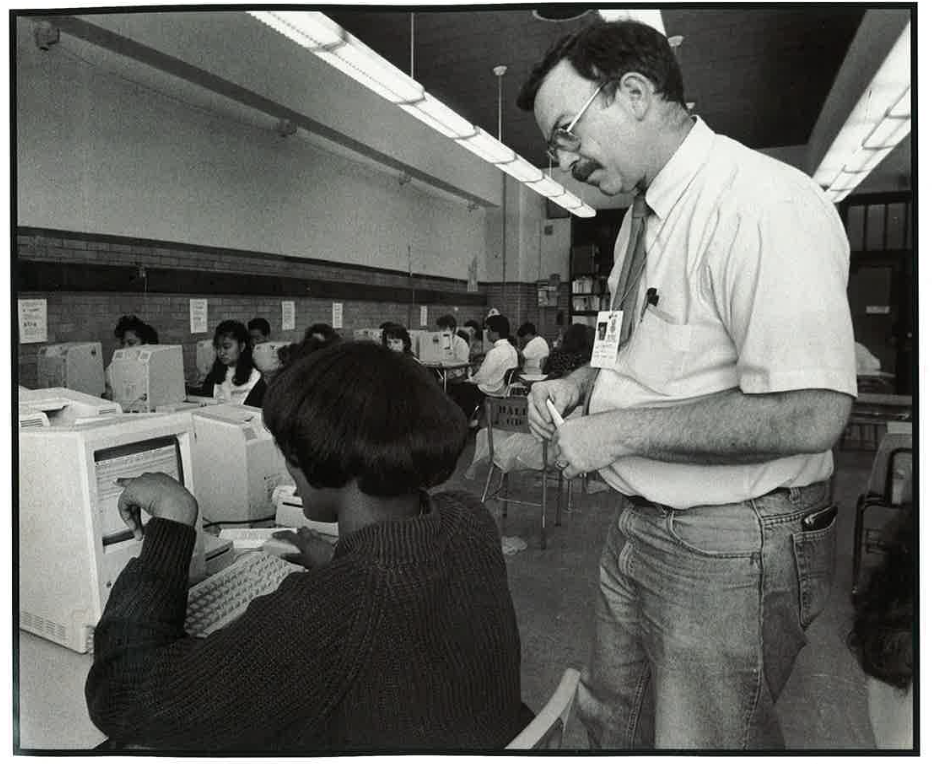 George Schmidt teaches his Amundsen students using Macintosh computers in the late 1980s. The photo and a story about George appeared in the Macintosh Writing Resource Guide, K-12. The 56-page book was published by Apple Computer, Inc. in 1990.